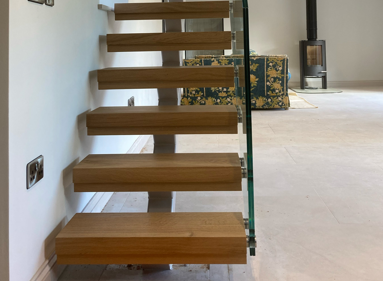 Bespoke Staircase Manufacturer 7 Floating oak treads on a metal spine with a glass balus