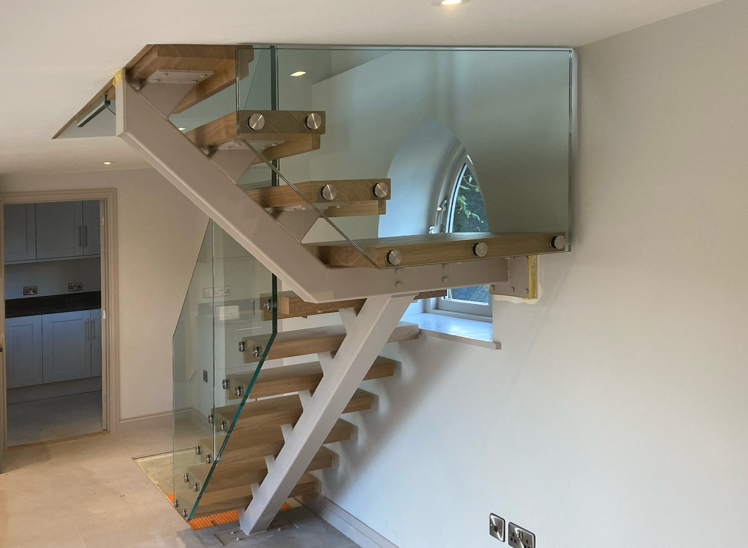 Bespoke Staircase Manufacturer 13 Metal staircase with a central spine, glass balustrade and oak treads — bespoke staircase by Reeve & Co, Suffolk