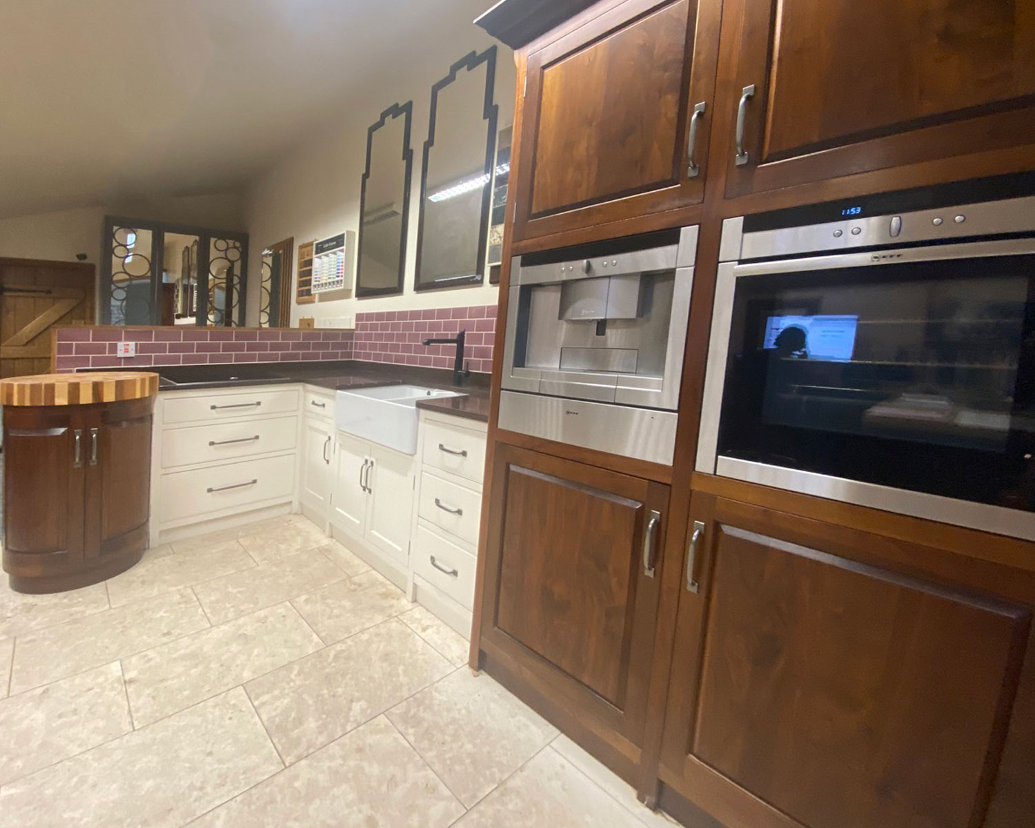 Suffolk kitchen with painted base units, walnut tall cupboards and curved island end