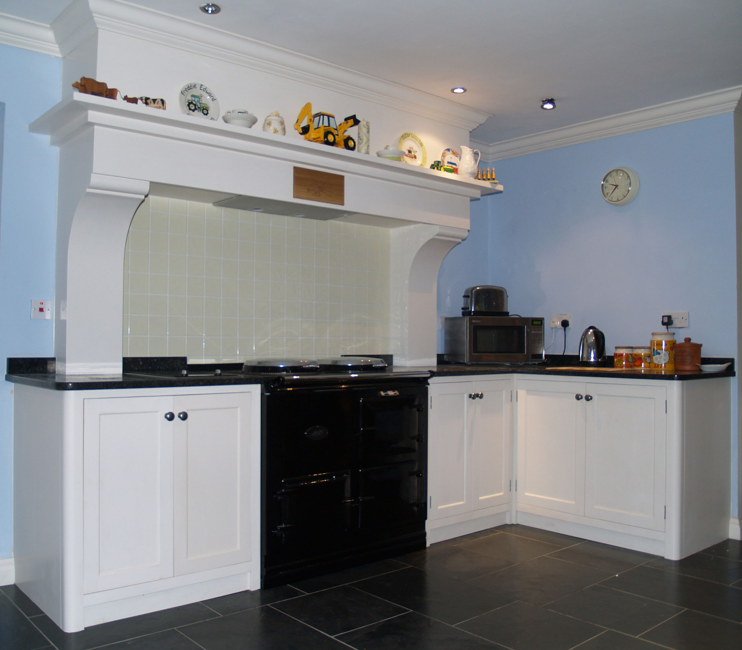 Painted kitchen with fireplace and stone top