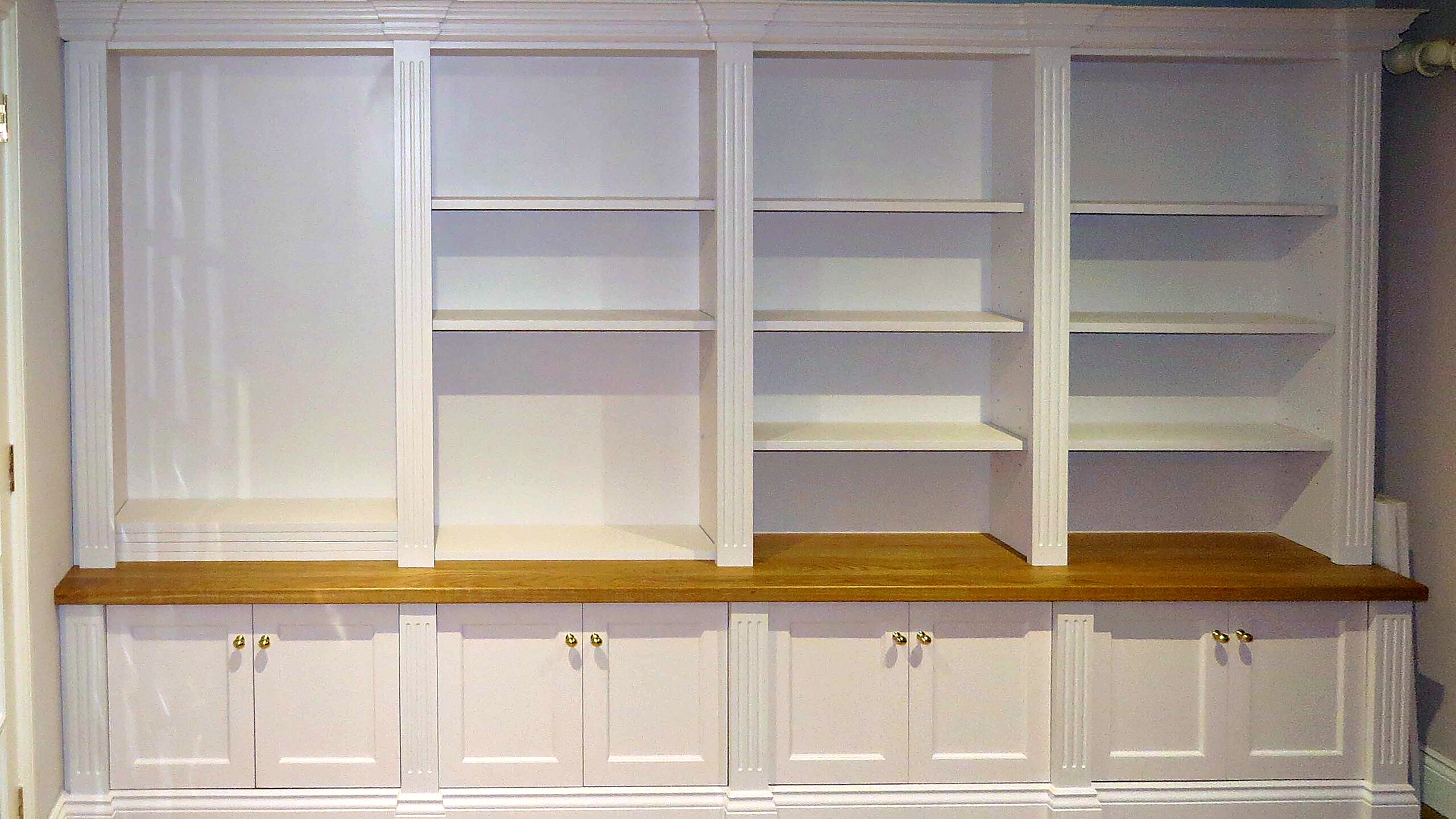 Bespoke fitted cabinet and bookcase in a private interior