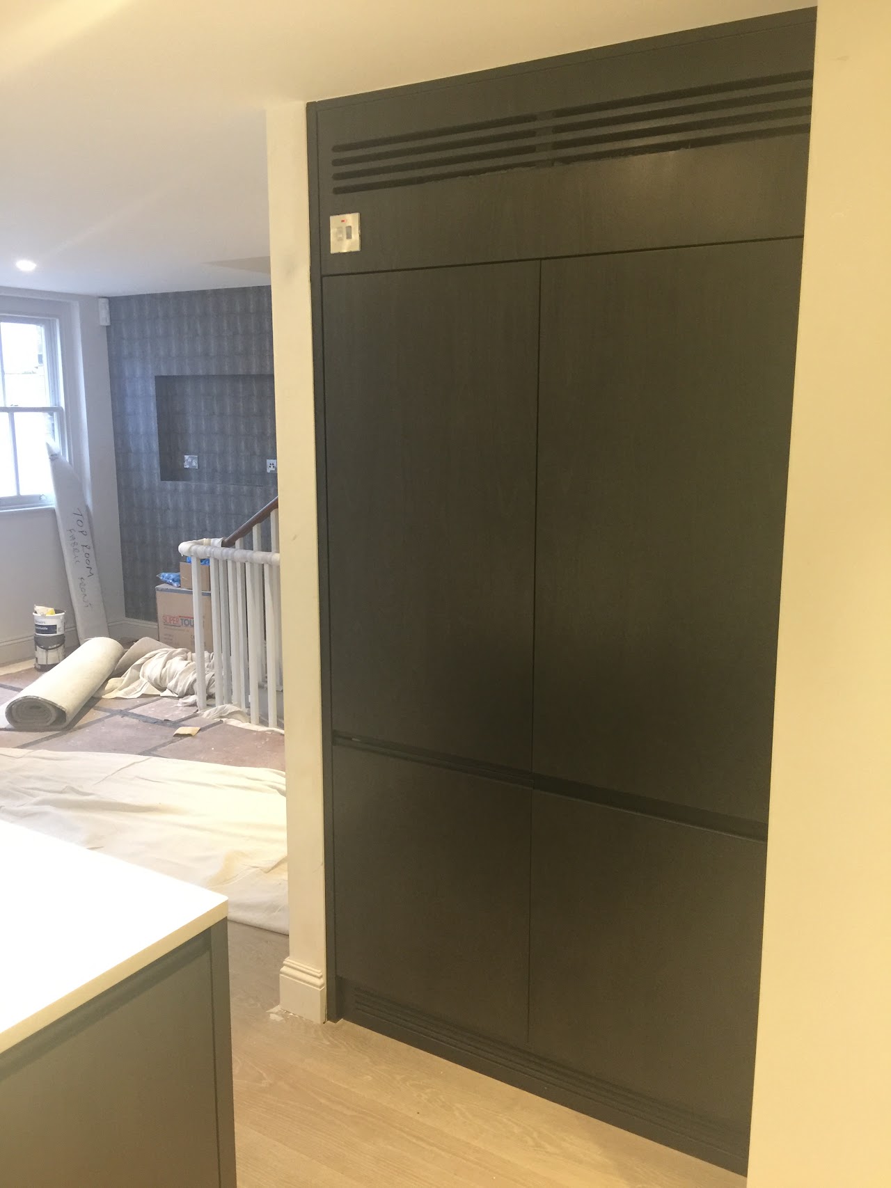 Full-height fitted kitchen cabinetry beside a window — bespoke joinery by Reeve & Co, South Kensington, London