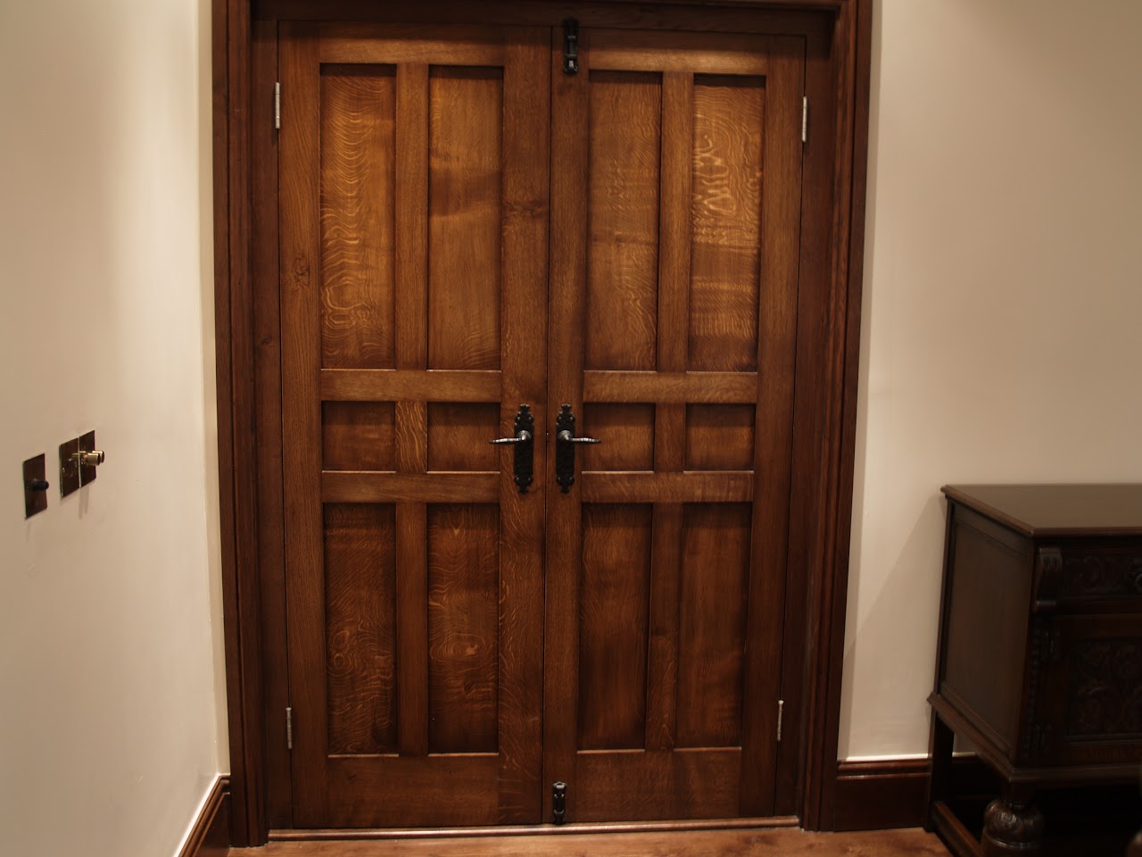 Bespoke dark oak panelled double doors with traditional ironmongery — joinery by Reeve & Co, Wealside