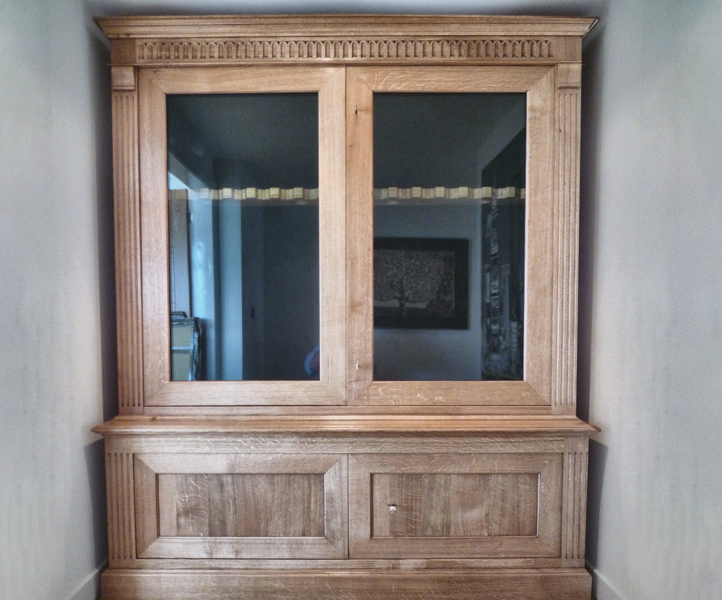Double-door glazed gun cabinet in oak