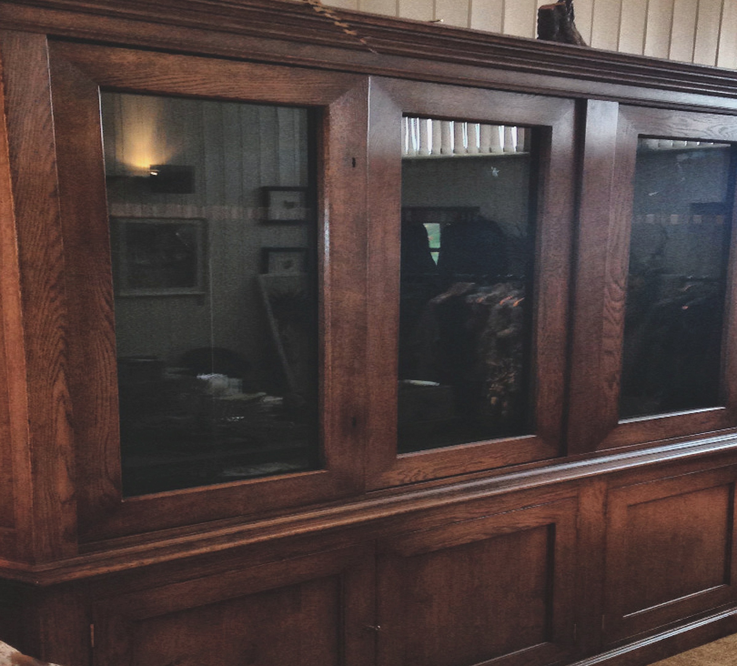 Bespoke Gun Rooms and Gun Cabinets 3 Wide four-door glazed gun cupboard in figured oak with panelled base, made for a large collection