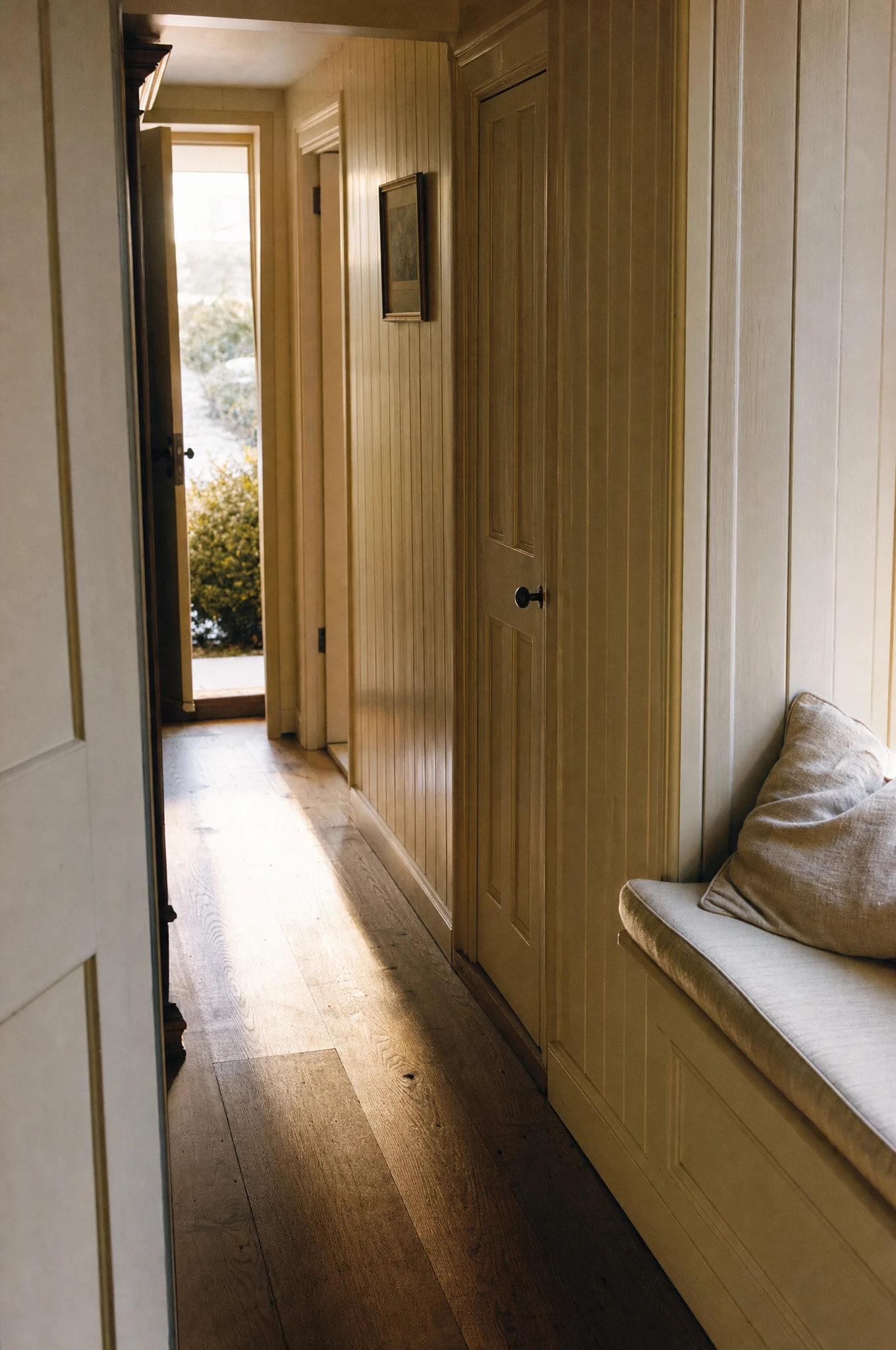 Painted tongue-and-groove panelling and a fitted window seat in a Suffolk coastal residence — Reeve & Co design study
